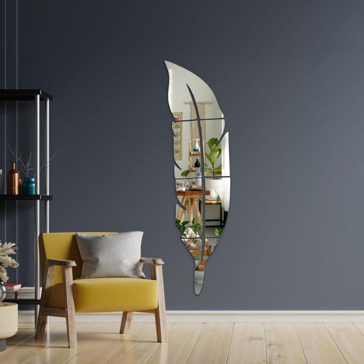 Feather mirror on white hallway wall with plants