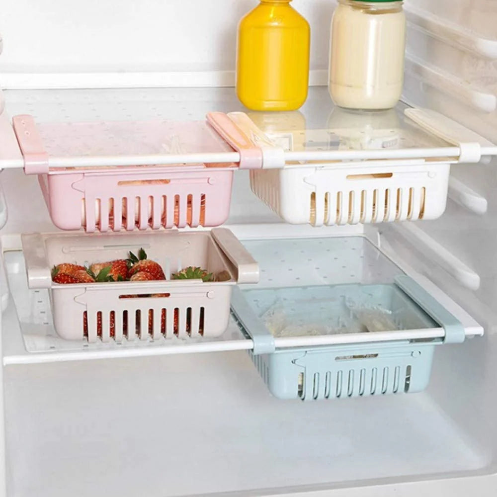 Expandable fridge baskets in pink and white on refrigerator shelf